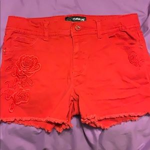 Red flower designed jean shorts.